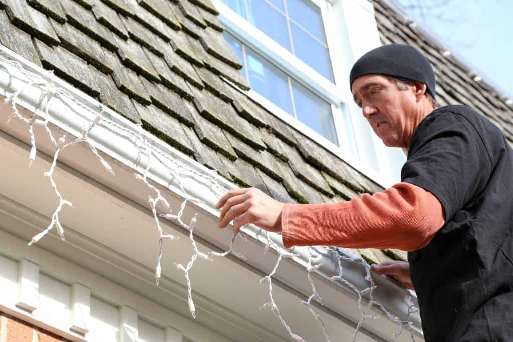 How to Stay Safe and Keep Your Roof Intact While Hanging Holiday Decorations